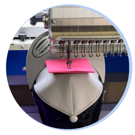 pufftimeline-1 Embroidery machine stitching a 3D puff embroidery design onto a hat with pink foam underneath — demonstrates the 'stitch over foam' technique using expertly digitized puff embroidery files for dimensional stitching results