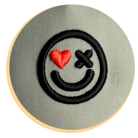 pufftimeline3 Finished 3D puff embroidery design featuring a smiley face with heart and X-eye details — showcasing the crisp, bold result of professional puff digitizing and foam embroidery techniques